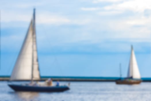 Blue sailboat - soft lens bokeh image. Defocused background