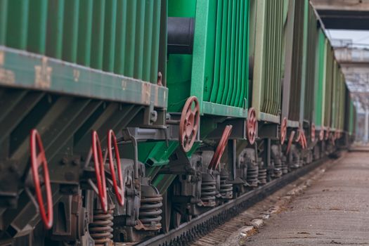 Green cargo wagons. Freight train in action