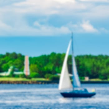 Blue sailboat - soft lens bokeh image. Defocused background