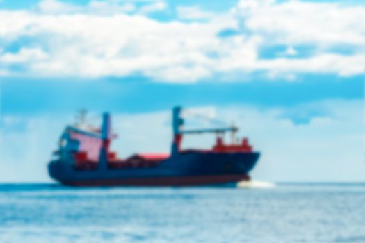 Blue cargo ship - soft lens bokeh image. Defocused background