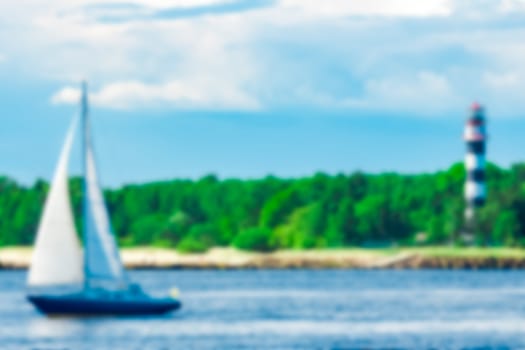 Blue sailboat - soft lens bokeh image. Defocused background