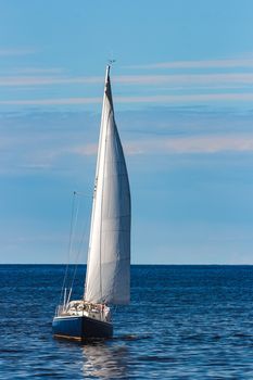 Blue sailboat in travel by Europe. Sea journey