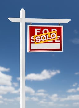 Right Facing Sold For Sale Real Estate Sign on a Blue Sky with Clouds.