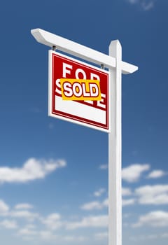 Left Facing Sold For Sale Real Estate Sign on a Blue Sky with Clouds.