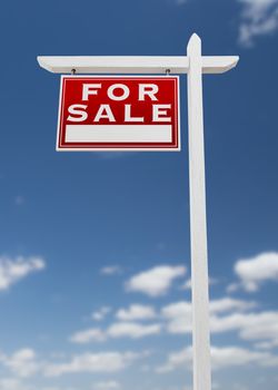 Left Facing For Sale Real Estate Sign on a Blue Sky with Clouds.