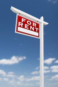 Left Facing For Rent Real Estate Sign on a Blue Sky with Clouds.