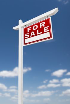 Right Facing For Sale Real Estate Sign on a Blue Sky with Clouds.