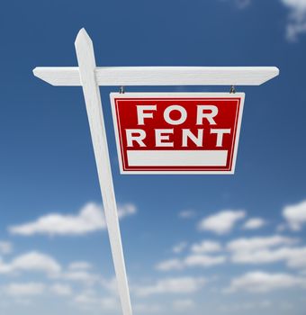 Right Facing For Rent Real Estate Sign on a Blue Sky with Clouds.