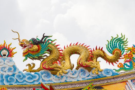 Beautiful chinese dragon statue with gray sky background.