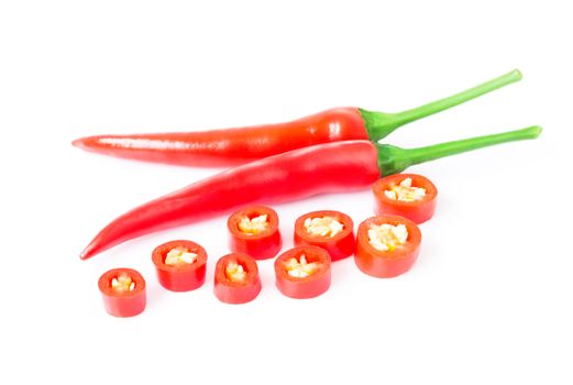 Closeup top red chili pepper with sliced on white background, raw food ingredient concept