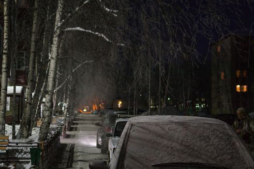 machines with snow in the evening night in the winter city