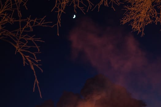 the moon and smoke a winter evening in the city of Nizhnevartovsk