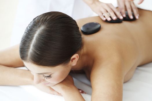 Girl on a stone therapy, hot stone massage