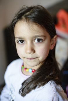 portrait of a 5 year old girl wearing pajamas in her home in the hall