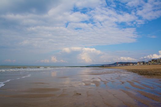 Trouville beach at low tide with cloudy colorful sky