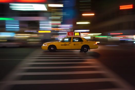 New-York taxi blazes through the night, speed light rays