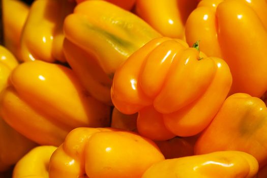 Shiny yellow peppers at the market