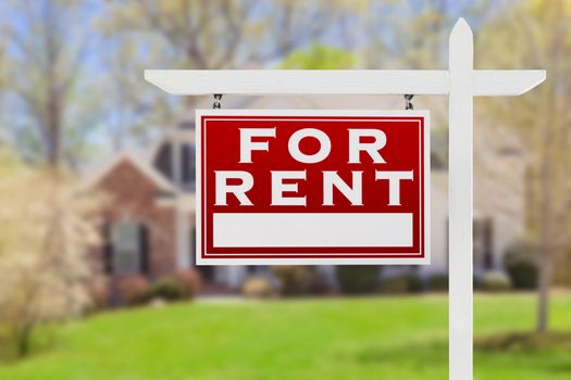 Left Facing For Rent Real Estate Sign In Front of House.