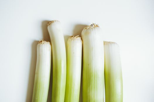 still life of vegetable leeks on white background