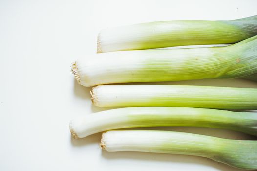 still life of vegetable leeks on white background