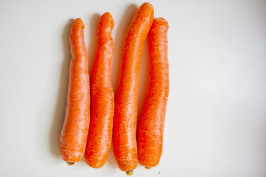 still-life photograph of carrots on white background