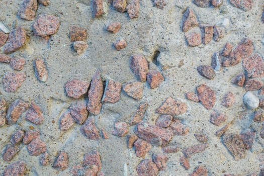 the texture of the stone in plaster red stones on a white background
