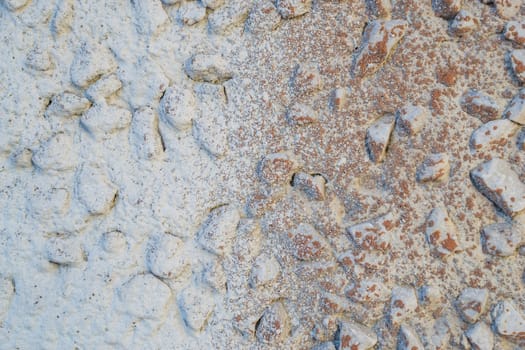 the texture of the stone in plaster red stones on a white background