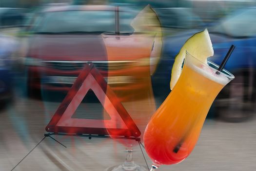 Cocktail glass with melon tip over in the background car crash scene intentionally blurred. Symbolic of alcohol consumption when driving.