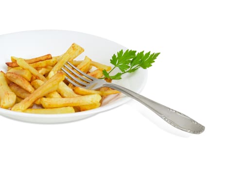 Fragment of the white dish with the French fries and twig of parsley and fork of stainless steel on a light background
