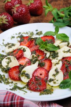 Light snack caprese with strawberries and mozzarella dressed   mint pesto