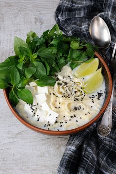 Rice soup with noodles and tofu flavored with lemon grass (basil), cilantro, sesame.