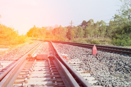 Railroad tracks in beautiful, Orange sunset in low clouds over railroad.