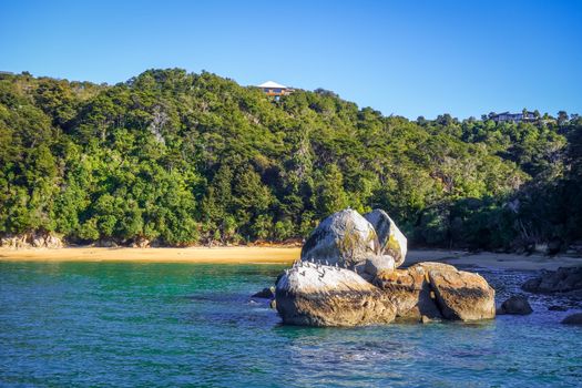 Round stone boulder and sand bay in Abel Tasman National Park. New Zealand