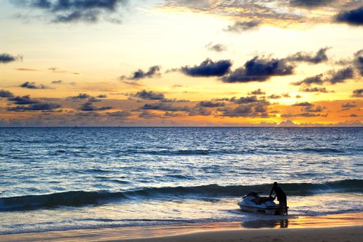 Sunset seascape.Beach and sports.water scooter