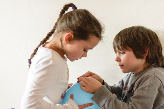 children with blue balloon and white background