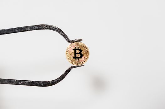 bitcoin electronic coin holding with a large caliper white background