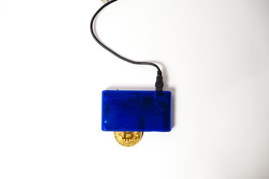 bitcoin electronic coin inside a digital card reader, white background