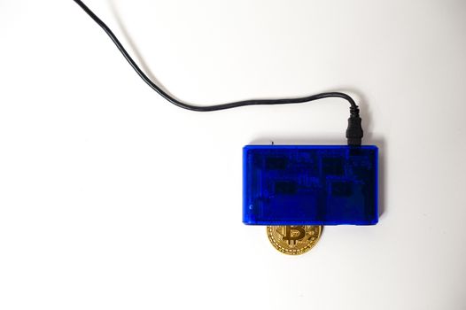 bitcoin electronic coin inside a digital card reader, white background