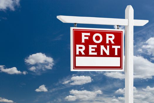 Left Facing For Rent Real Estate Sign Over Blue Sky and Clouds With Room For Your Text.