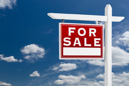 Left Facing For Sale Real Estate Sign Over Blue Sky and Clouds With Room For Your Text.