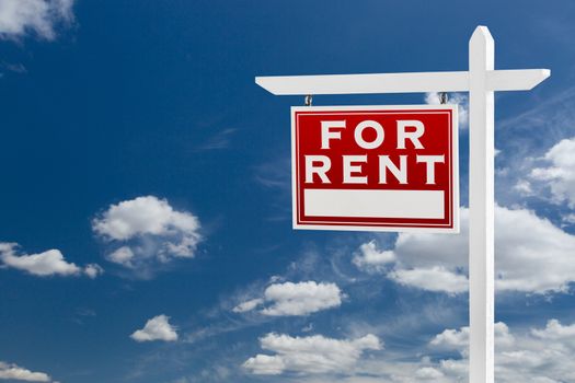 Left Facing For Rent Real Estate Sign Over Blue Sky and Clouds With Room For Your Text.