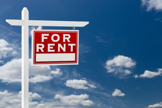 Right Facing For Rent Real Estate Sign Over Blue Sky and Clouds With Room For Your Text.