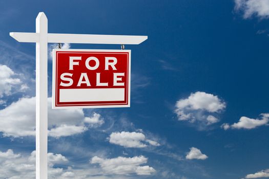 Right Facing For Sale Real Estate Sign Over Blue Sky and Clouds With Room For Your Text.