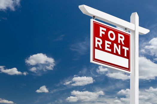 Left Facing For Rent Real Estate Sign Over Blue Sky and Clouds With Room For Your Text.