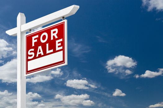 Right Facing For Sale Real Estate Sign Over Blue Sky and Clouds With Room For Your Text.