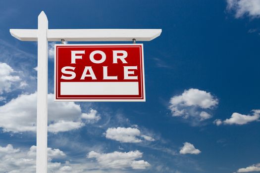 Right Facing For Sale Real Estate Sign Over Blue Sky and Clouds With Room For Your Text.