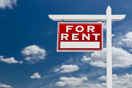 Left Facing For Rent Real Estate Sign Over Blue Sky and Clouds With Room For Your Text.