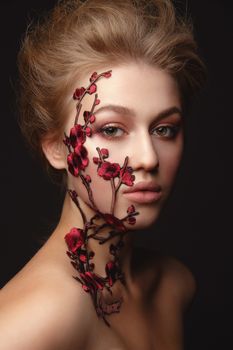 Studio Portrait of a young woman with flower makeup