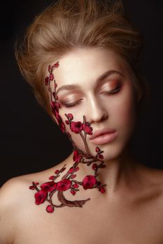 Studio Portrait of a young woman with flower makeup