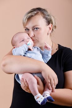 mother with her cute little baby boy, first month of the new life, studio shoot